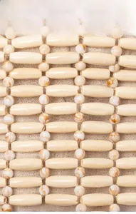 Detail of wooden beaded handbag showing marble pattern beads and beige linen lining