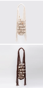 Detailed macro of handmade woven mesh bags with shell accents and fringe tassels