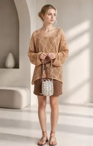 Detail showing handwoven pearl shoulder bag with hollow knit sweater and brown skirt