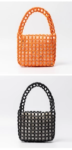 Close-up of handmade beaded tote bags in orange and black with woven inner pouches