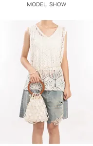 Detail of white hollow crochet knit top paired with a vintage pearl woven handbag