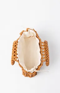 Top view showing the spacious interior and drawstring lining of the beaded wood handbag