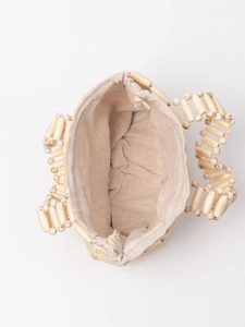 Contrast color hollow wooden bead handbag with linen drawstring lining shown from top view