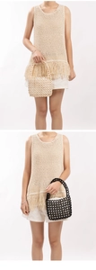 Detailed view of bohemian crochet knit vest with long tassels and beaded handbags
