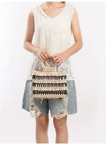Detail of handmade beaded tote bag with black and white stripes and round handle