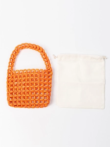 Handmade orange beaded bag with wooden beads and white drawstring pouch for beach vacation
