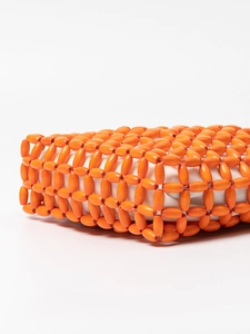 Bright orange beaded handmade woven handbag for beach vacation with white fabric lining