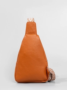 Brown orange leather sling bag with ethnic style woven strap and metal zipper detail