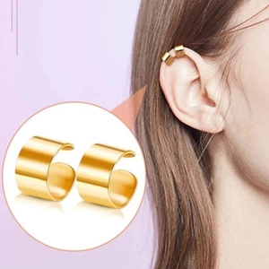 Detail view of gold U-shaped ear cuffs on model showing polished metal finish and fit