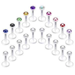 Dettaglio di 18 piercing per labbra con cristalli colorati e aste flessibili trasparenti