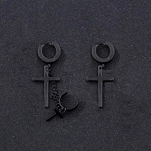 Macro shot of black punk cross earrings and chain ear cuff on textured background