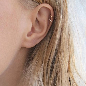 Polished gold double-layer ear cuff earring shown on ear for minimalist jewelry style