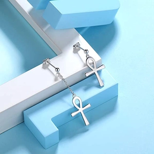 Asymmetric silver Ankh cross earrings with long chain on geometric background