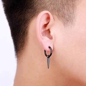Punk style black hoop earring with long cone pendant worn by male model on a plain background