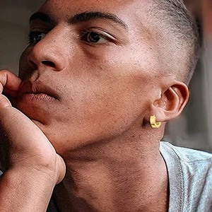 Minimalist gold hoop earring on model showing sleek polished metal finish and compact design