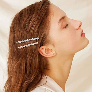 Elegant wave-shaped hair clip set with white pearls and sparkling rhinestones on gold and silver