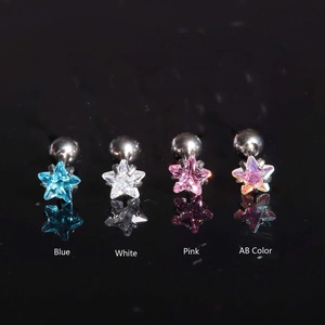 Detailed view of four pairs of colorful star stud earrings in blue white and pink