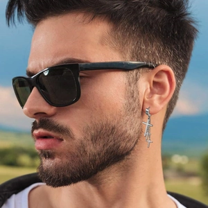 Mens stainless steel hoop earrings featuring triple dangling silver crosses on male model