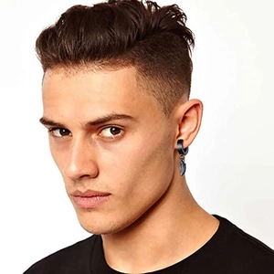 Men's black stainless steel hoop earring with leaf pendant displayed on male model