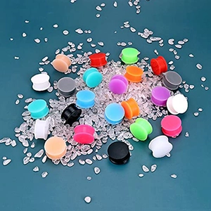 Solid silicone ear gauges in multiple colors stacked on decorative clear stones