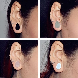 Macro display of teardrop gauges in opal, rose quartz, green aventurine, and black onyx stones