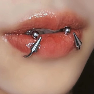 Punk silver stainless steel horseshoe lip rings with spike and ball ends on pink lips