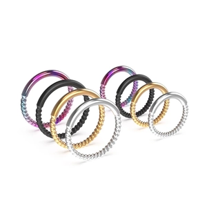Detail of twisted and smooth stainless steel nose rings in three various sizes and colors