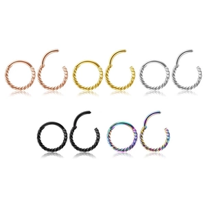 Detailed view of twisted hinged rings in five metallic finishes showing open and closed states