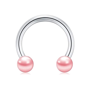 Macro detail of high polished horseshoe barbell with soft pink pearl beads on both ends