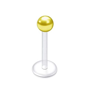 Macro detail of 16G piercing stud featuring a gold sphere top and clear bioflex base