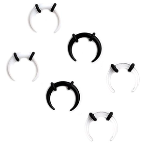 Macro detail of acrylic horn ear tapers in black, white, and clear with rubber rings