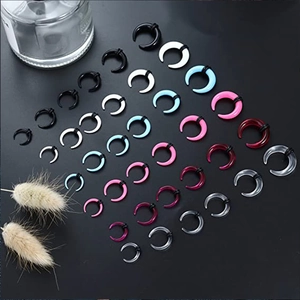 Macro shot of assorted colorful UV acrylic crescent ear tapers with black rubber O-rings