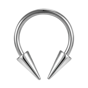 Macro view of polished stainless steel horseshoe piercing with sharp cone ends
