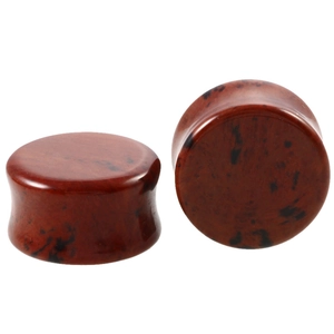 Detail of double flare ear plugs with red and black obsidian stone texture and polished finish