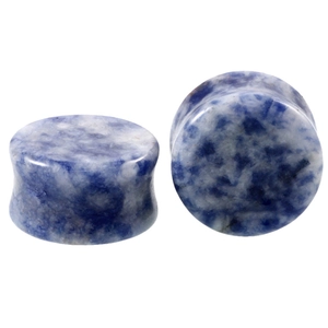Macro shot of polished blue marble natural stone ear plugs with double flared design
