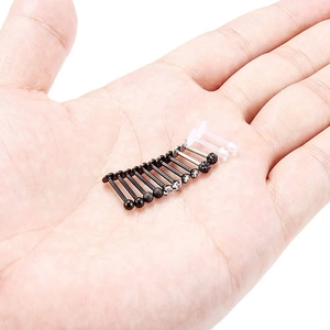 12-piece stainless steel and acrylic lip stud set shown in palm for size reference