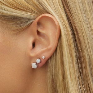Three-piece stainless steel opal studs set on ear with gradual sizes and 4-prong settings