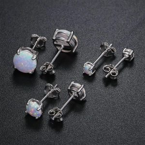 Three pairs of white opal stud earrings in 925 silver with four-claw setting