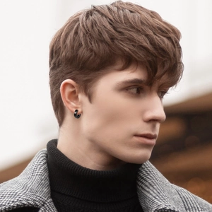 Minimalist matte black titanium steel hoop earrings for men in a stylish urban setting