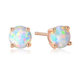Macro detail of round white opal earrings in rose gold four-claw setting with reflections