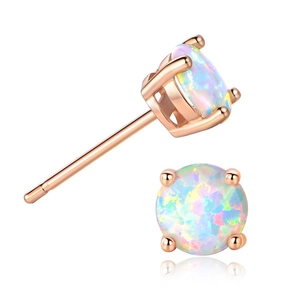 Detail view of round opal stud earrings featuring four-prong rose gold plating setting