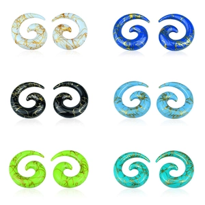 Set of six colorful acrylic spiral ear tapers with golden marble patterns on white background