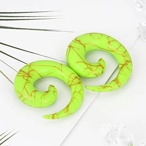 Detailed view of neon green acrylic spiral ear tapers with golden marble patterns