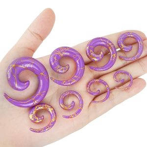Purple acrylic spiral ear gauges set with gold foil texture in seven different sizes