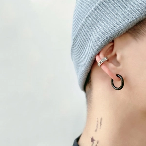 Three-piece stainless steel ear cuff set with silver and black matte finish on model