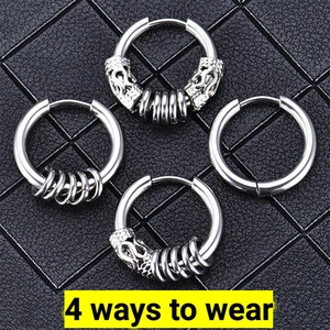 Detailed view of silver stainless steel hoop earrings set with dragon head carvings on leather