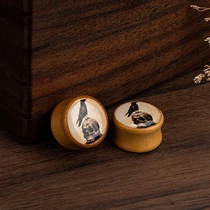 Gothic wood ear plugs featuring a detailed crow and skull design on natural wood base