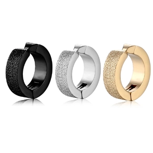 Detail view of steel clip-on earrings in black, silver, and gold with sandblasted finish