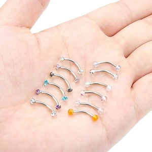 Set of 12 stainless steel curved barbells with colorful glitter balls and CZ in hand