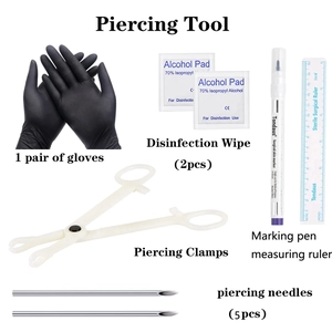 Professional body piercing kit with sterile needles, gloves, clamps, and marking pen set